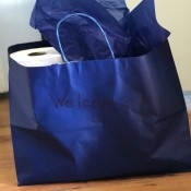 A gift bag filled with cleaning supplies as a welcome gift.
