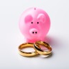 Piggy Bank with a set of wedding rings.
