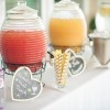 Canisters of different types of punch at a wedding.