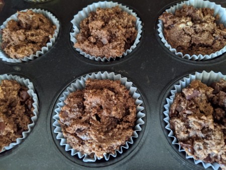 Chocolate Muffins in baking papers in tray