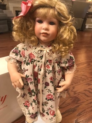 Value of a Danbury Mint Doll - blond child doll wearing a floral dress