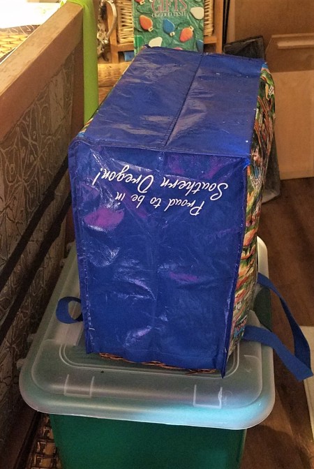 A shopping bag upended on a container to dry.
