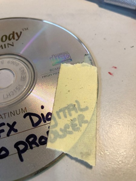 Making Feather Bookmarks from CDs - use masking tape to remove the rest of label