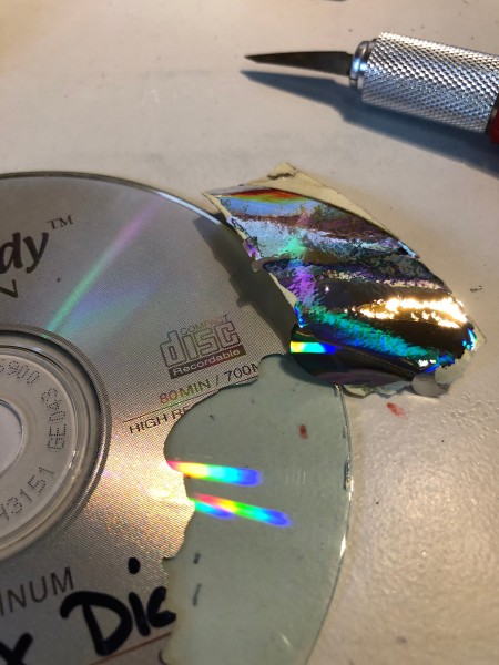 Making Feather Bookmarks from CDs - peeling off the label