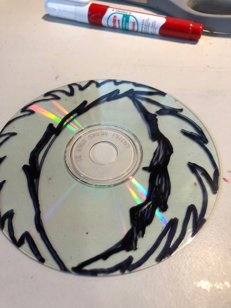 Making Feather Bookmarks from CDs - use black marker to feather edges