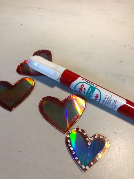 Recycled CD Mirrored Hearts - use the white out marker to add white dots to the red outlines