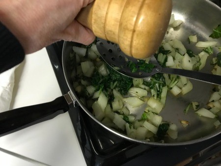 salting Stir Fried Bok Choy in pan