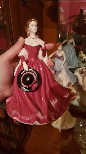 Identifying a Figurine - figurine of a woman in a long red dress holding a black hat with red bow
