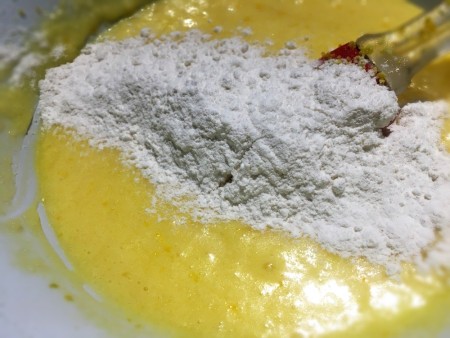 adding flour to batter