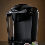 A Keurig coffee maker with some pods.