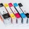 A collection of inkjet printer cartridges.
