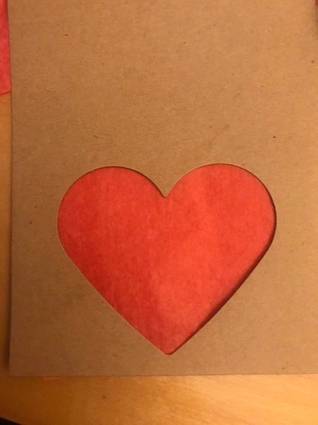 Simple Heart Garland - red tissue paper behind the heart cut out