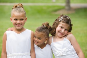 3 girls wearing a white dresses.