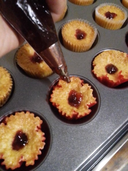 adding jam to Cupcakes