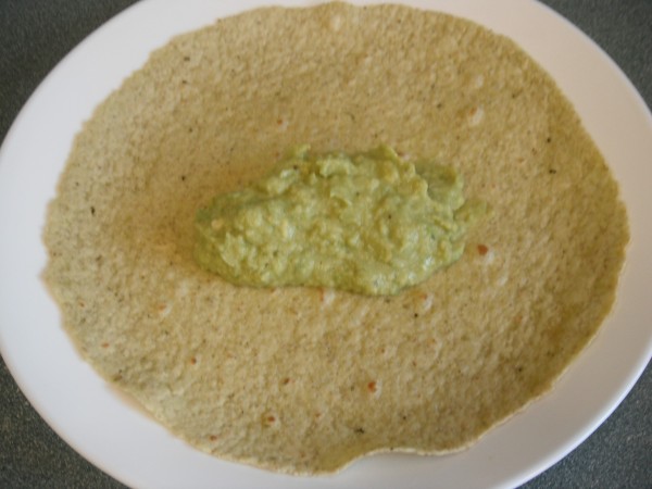 A serving of guacamole in a tortilla.