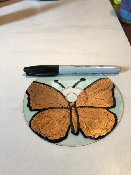 Golden Butterfly Suncatcher - line drawn around the gold polish edges