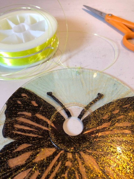 Golden Butterfly Suncatcher - cut a piece of nylon fishing line for hanging and tie to the hole