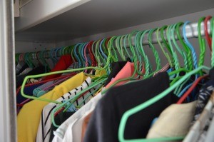 A closet full of clothes on hangers.