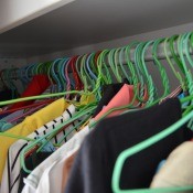 A closet full of clothes on hangers.