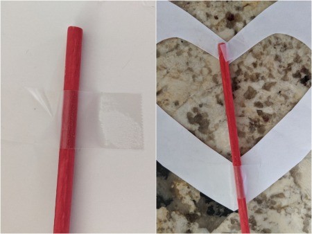 Paper Heart Display - taping second open center heart made from child's artwork to a dowel