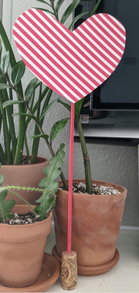 Paper Heart Display - red and white heart standing next to some potted plants