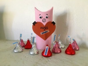 Hogs and Kisses Candy Holder - finished hog holder surrounded by red and silver wrapped Kisses