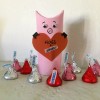 Hogs and Kisses Candy Holder - finished hog holder surrounded by red and silver wrapped Kisses