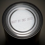 An expiration date stamped on the top of a food can.