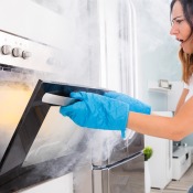 An oven that has smoke coming from the door.