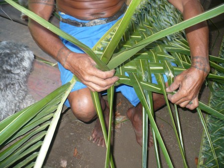 Coconut Leaf Panels - lifting some of the leaves as part of the weaving process, three at a time