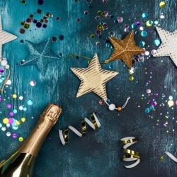 A blue background with stars, ribbons and a bottle of champagne.