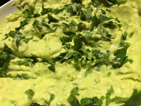 adding onion to Avocado Cream Sauce