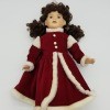 Identifying a Porcelain Doll - doll wearing a long red coat style dress with white fur trim