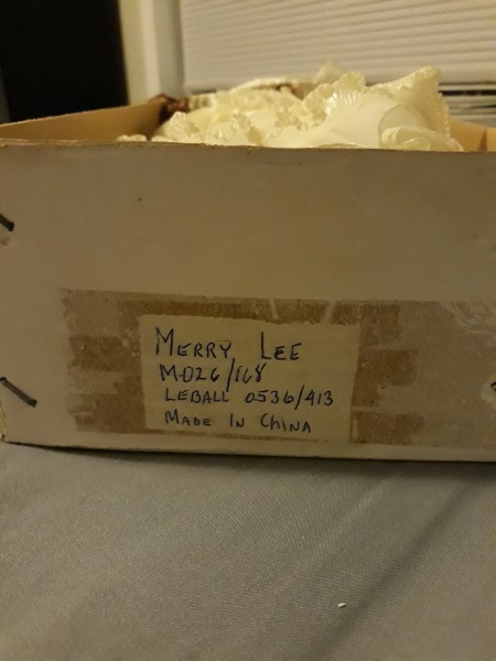 A box that contains a porcelain doll.