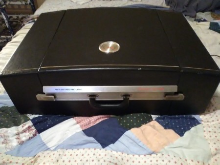 A portable record player in a case.