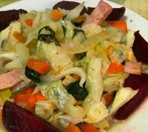A plate of ham and cabbage stir fry.