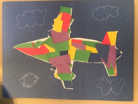 Paper Mosaic Art for Kids - mosaic plane on black paper with clouds drawn on