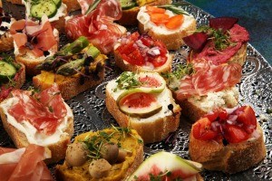 A platter of assorted crostini appetizers.