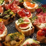 A platter of assorted crostini appetizers.