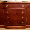 A wooden dresser with metal drawer pulls.