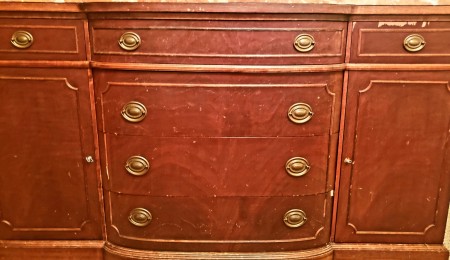 A wooden dresser with metal drawer pulls.