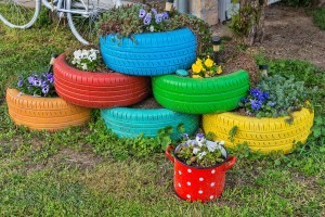 A colorful collection of car tires used as planters.