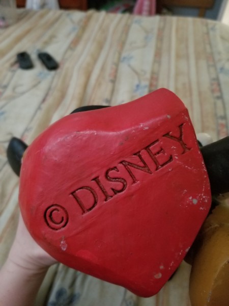 A Disney copyright marking on the bottom of a figurine.
