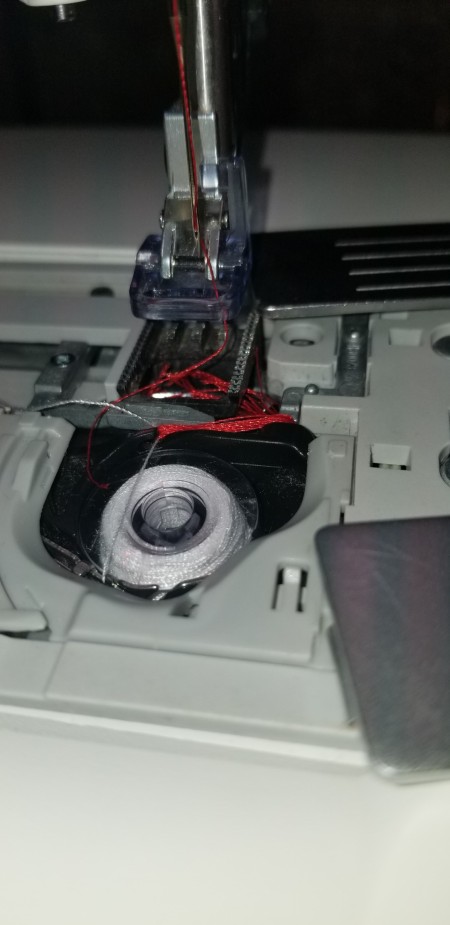 The needle of a sewing machine.