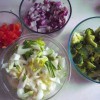 Chopped vegetables in small glass bowls.