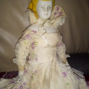 A porcelain figurine with a floral dress.
