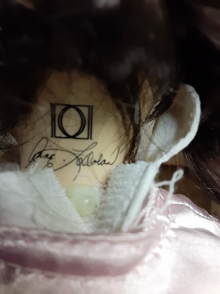 A marking on the back of a porcelain doll.