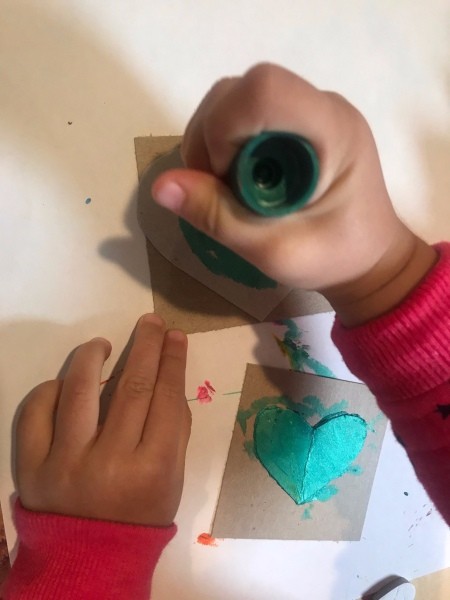 Handmade Valentine's Day Cards - child using a marker to decorate card