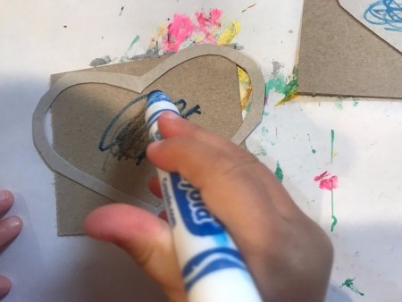 Handmade Valentine's Day Cards - coloring the inside of a heart outline shape with a blue marker