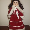 A collectible doll in a red and white Christmas outfit.